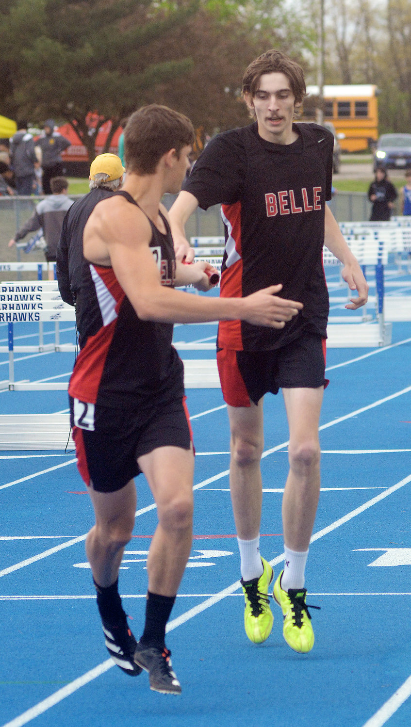 Corey McDaniel (far left) reaches for the baton from Keith Rose for Belle’s Tigers during the varsity boys 4x800-meter relay at the Gasconade Valley Conference (GVC) Track Meet held Saturday at Bourbon High School.